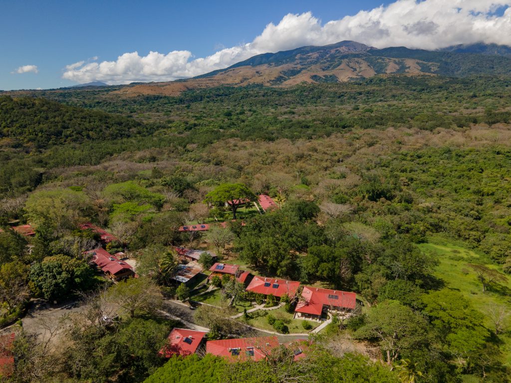 aerial view of hotel with volcano in background
