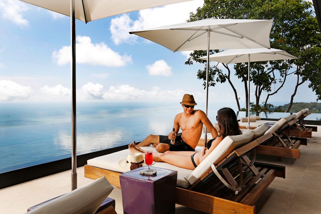 couple relaxing by pool