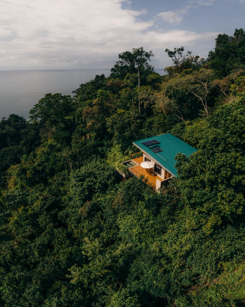 A panoramic carousel of Awā Beachfront Hotel in Puerto Viejo, showcasing its boutique jungle exterior, lit-up night suites, gourmet dining terrace, and beachfront lounge overlooking the Caribbean Sea.