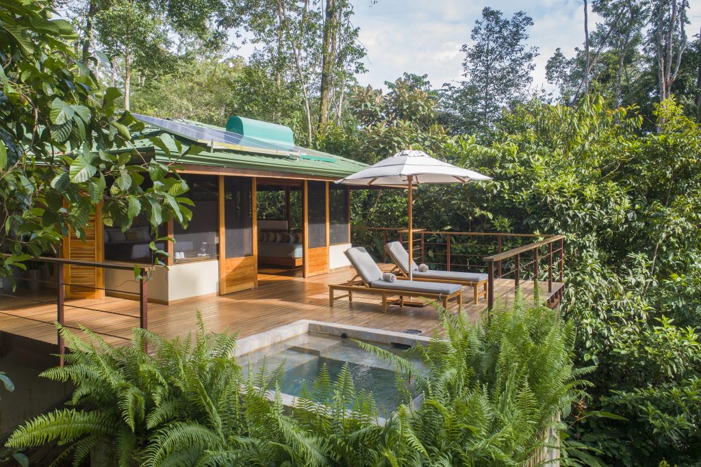 Featured thumbnails of El Remanso Lodge showcasing a secluded rainforest cabin on a hillside, a multilevel jungle lodge, and a private luxury deck with sun loungers and a plunge pool.