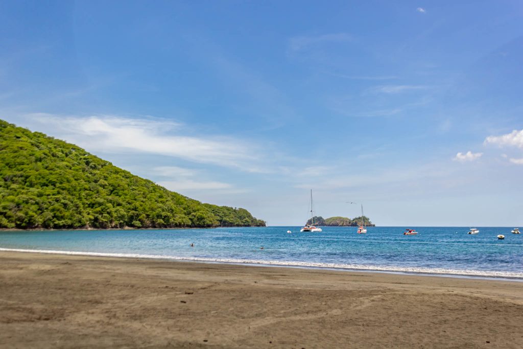 A majestic aerial view of a volcanic crater featuring a turquoise lake at its center, showcasing the geological wonders of Costa Rica on an adventure tour with Horizontes Nature Experiences.